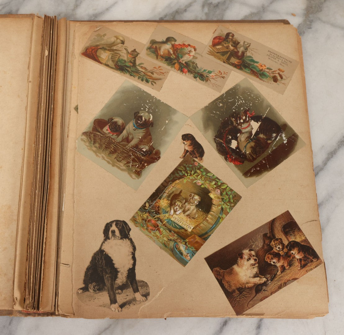 Lot 119 - Antique Victorian Scrapbook Album Cover With Playing Cards And Dogs Graphics, With Many Lithographed Trade Cards, Holiday Cards, And Die Cuts, 100+ Pieces