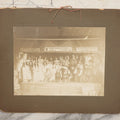 Lot 125 - Antique Boarded Photograph Of Cast Of Biblical Themed Play Onstage In Costume, With Advertisements Above Stage For Gem Drug Store, Farmers Bank, And Trawick & Neville Suppliers Of Merchandise, Likely From Souris, North Dakota