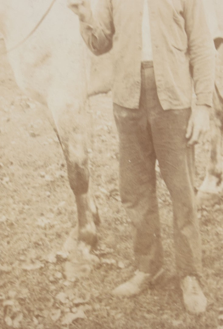 Lot 128 - Antique Boarded Photograph Of An Elderly Cowboy Smoking A Pipe Beside His White Horse