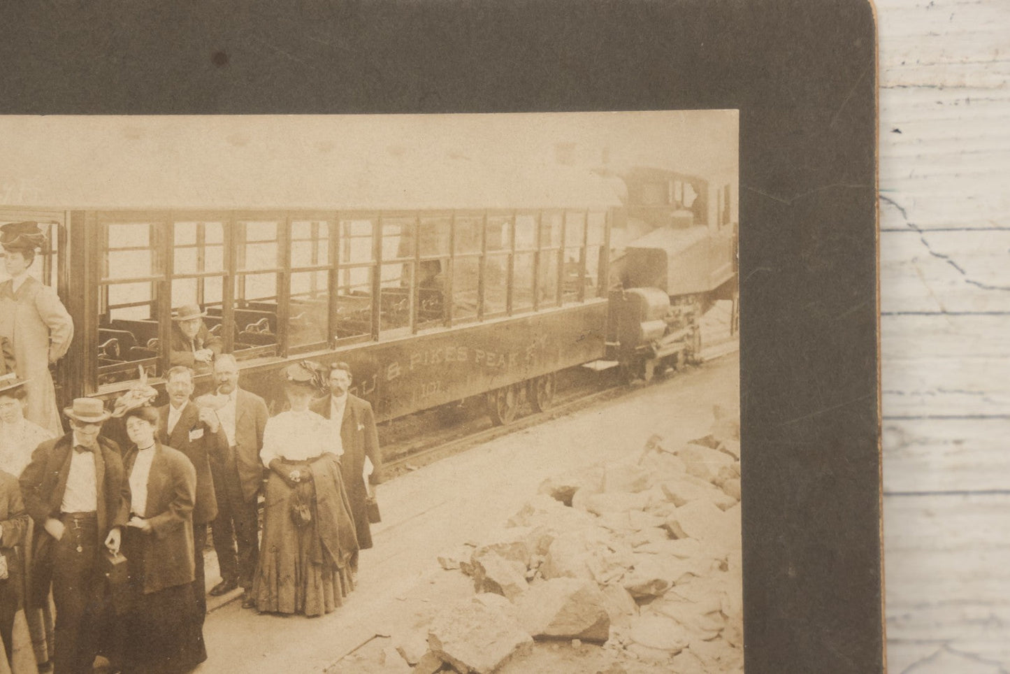 Lot 129 - Antique Boarded Souvenir Photograph Of Travelers Beside Rail Car On The Manitou & Pike's Peak Cog Railway, Rocky Mountains, Colorado, Photo By J.G. Hiestand, Official Photographer, Dated 1907