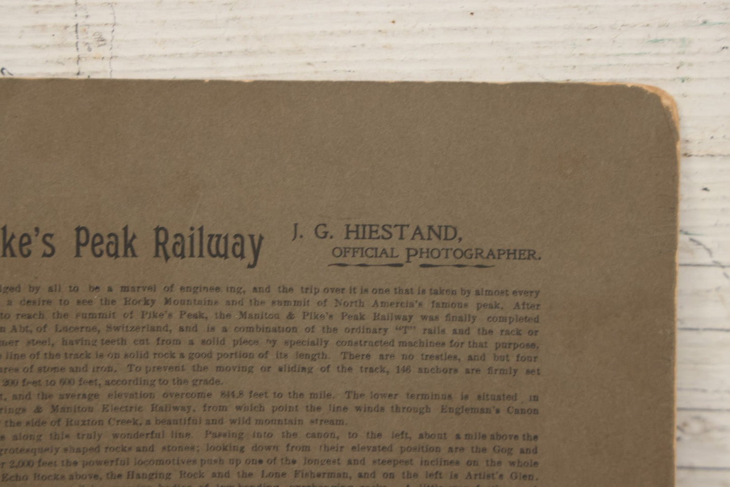 Lot 129 - Antique Boarded Souvenir Photograph Of Travelers Beside Rail Car On The Manitou & Pike's Peak Cog Railway, Rocky Mountains, Colorado, Photo By J.G. Hiestand, Official Photographer, Dated 1907