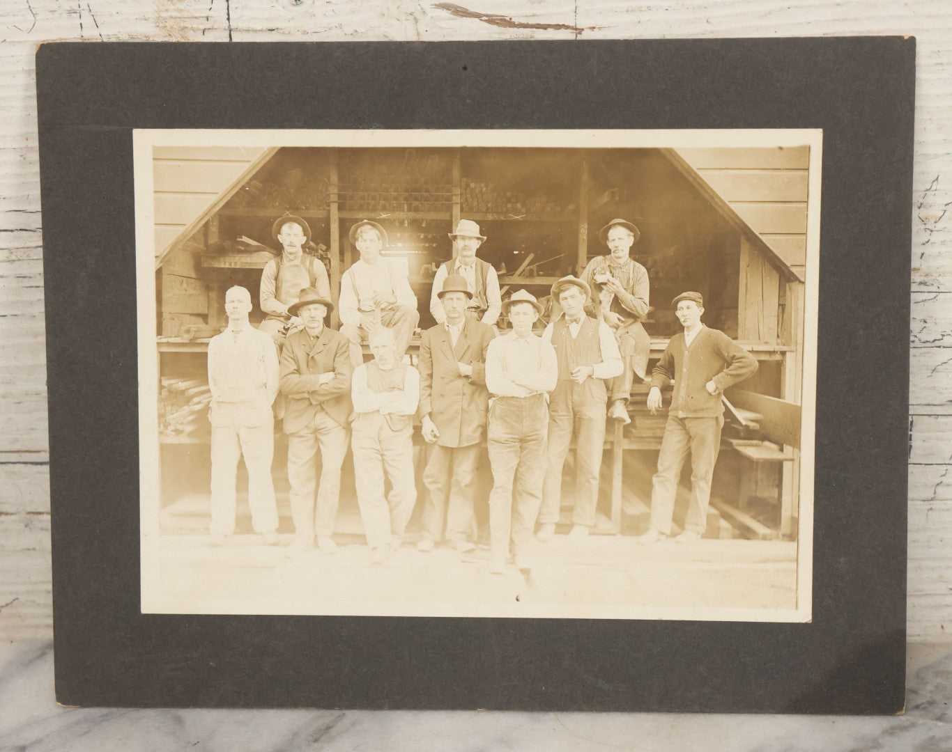 Lot 131 - Antique Boarded Occupational Photograph Of Lumber Mill Workers, Including Their Shop Dog, Posing Before Dimensional Lumber Inventory
