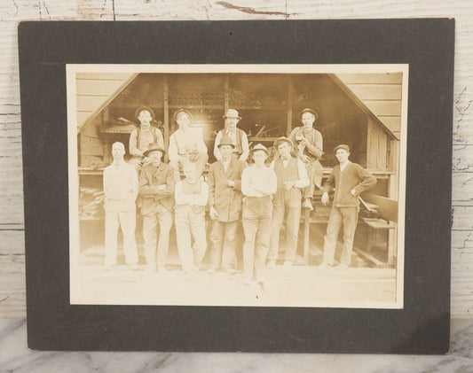Lot 131 - Antique Boarded Occupational Photograph Of Lumber Mill Workers, Including Their Shop Dog, Posing Before Dimensional Lumber Inventory