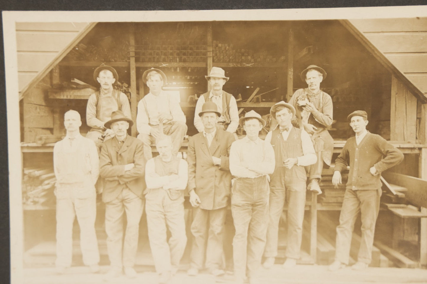 Lot 131 - Antique Boarded Occupational Photograph Of Lumber Mill Workers, Including Their Shop Dog, Posing Before Dimensional Lumber Inventory