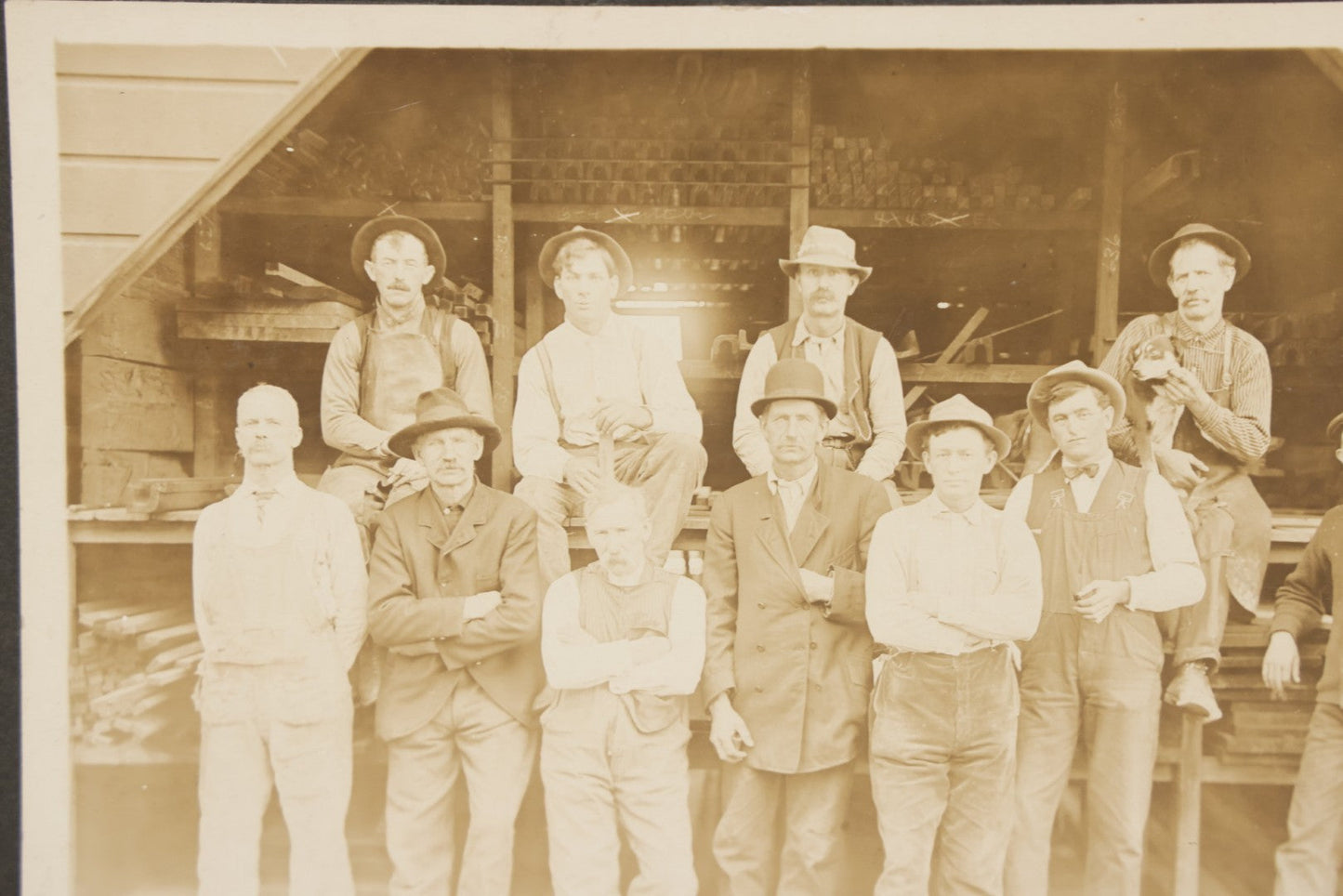 Lot 131 - Antique Boarded Occupational Photograph Of Lumber Mill Workers, Including Their Shop Dog, Posing Before Dimensional Lumber Inventory