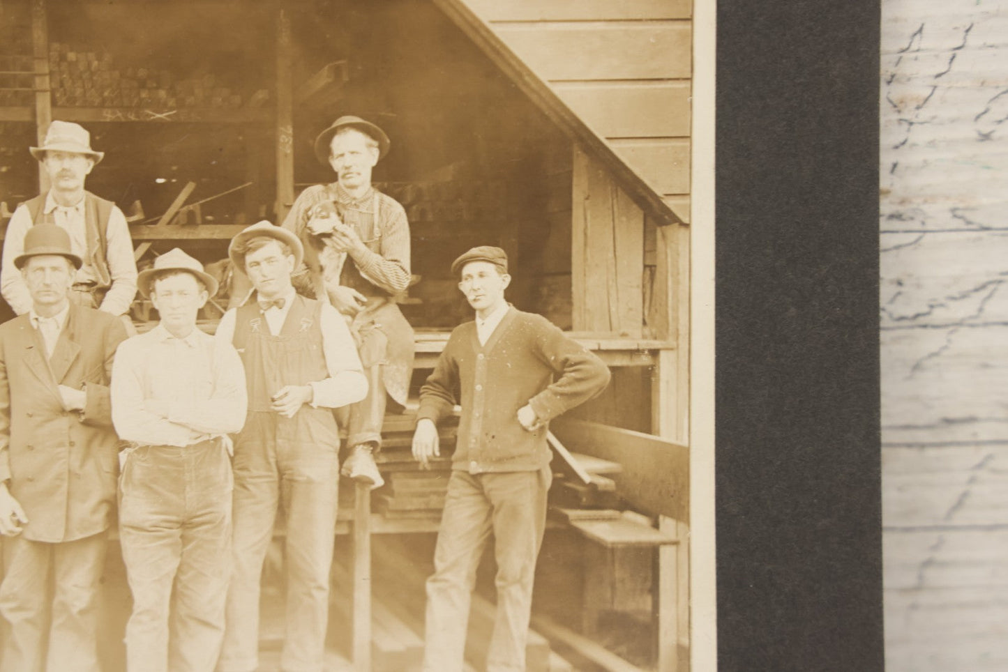 Lot 131 - Antique Boarded Occupational Photograph Of Lumber Mill Workers, Including Their Shop Dog, Posing Before Dimensional Lumber Inventory