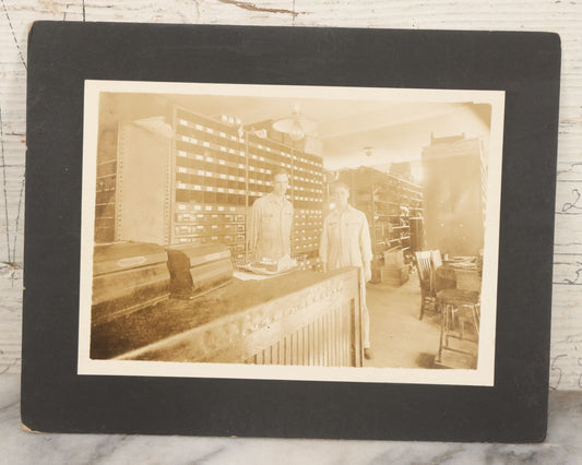 Lot 135 - Antique Boarded Occupational Photograph Of Two Workers In Embroidered Coveralls Working In A Parts Shop 