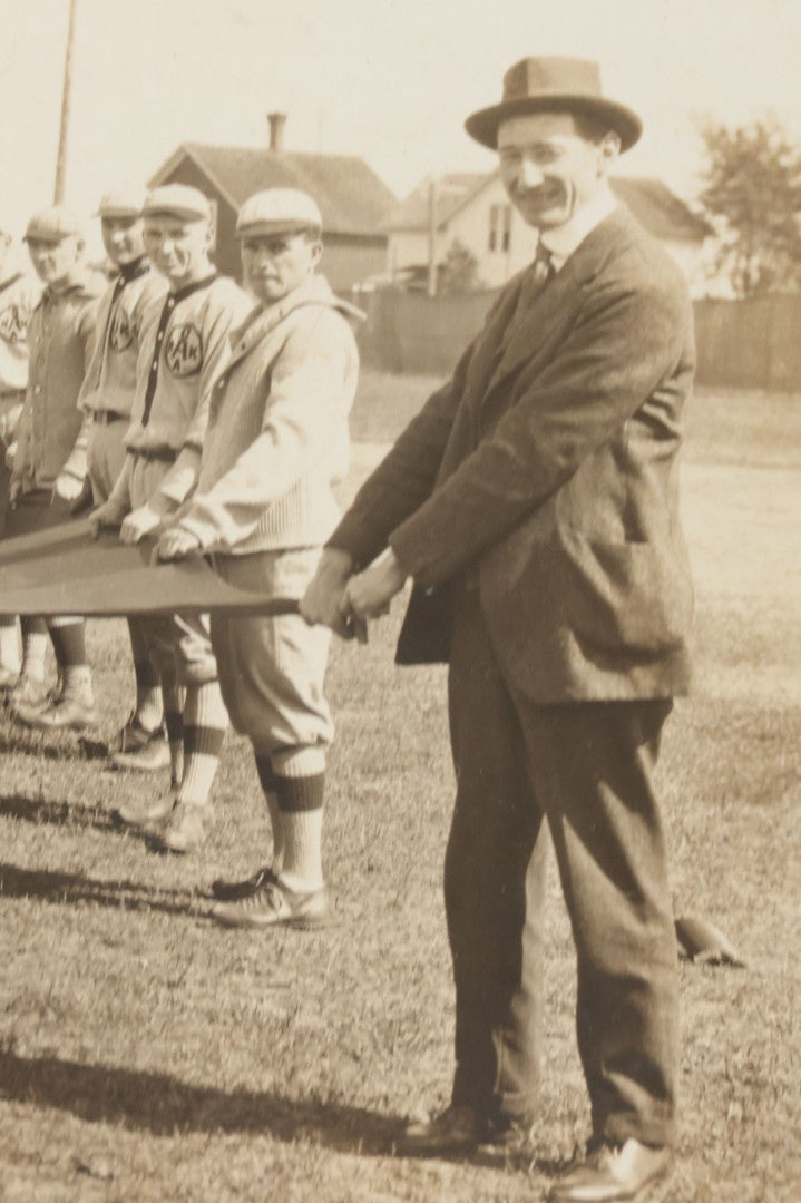 Lot 139 - Antique Boarded Photograph Of The Players Of A Baseball Team In Uniform Posing With A Large Flag, Uniforms Say "Royal League" With Patches Visible