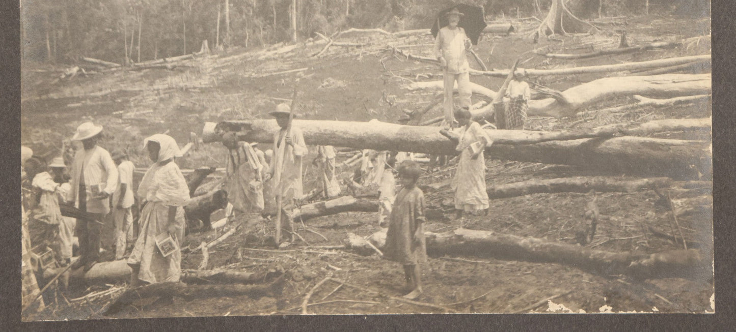 Lot 152 - Antique Boarded Photograph Of Group Of Men Women And Children Walking Through A Barren Deforested Landscape Including Tall Man Posing On Log With Parasol