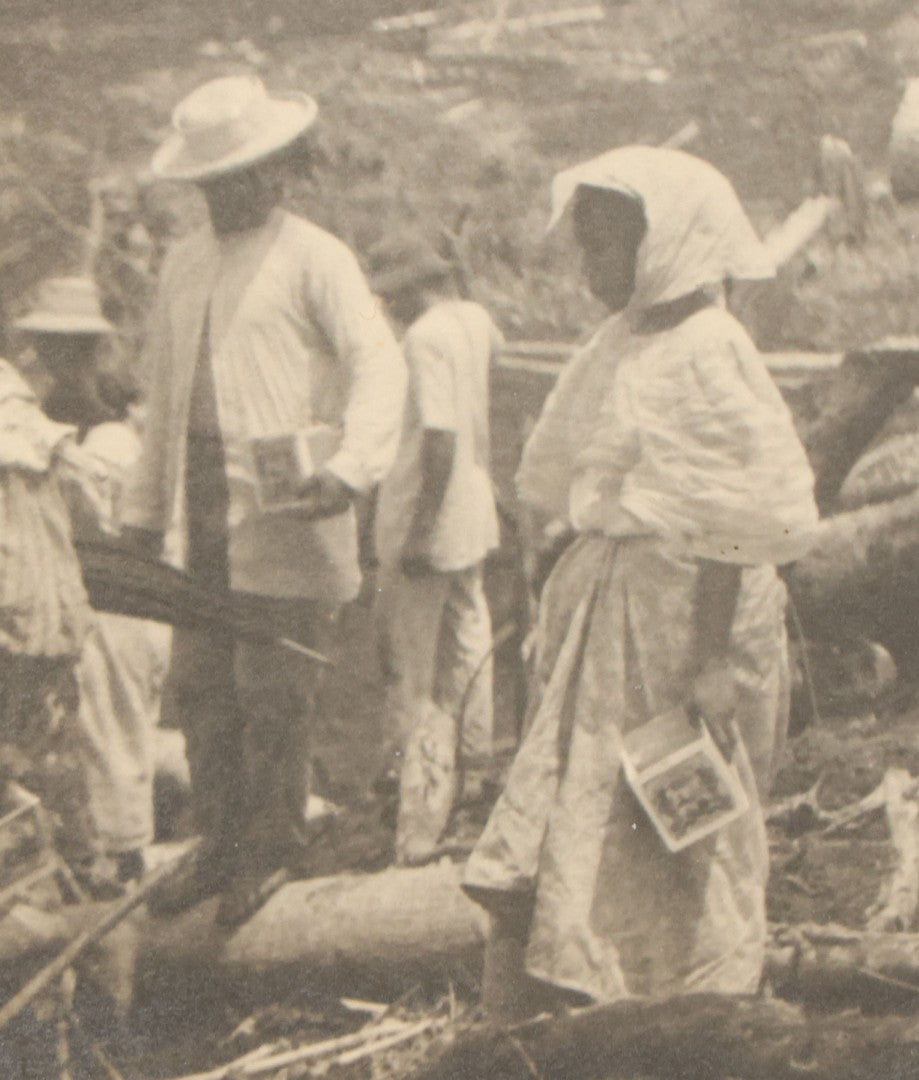 Lot 152 - Antique Boarded Photograph Of Group Of Men Women And Children Walking Through A Barren Deforested Landscape Including Tall Man Posing On Log With Parasol