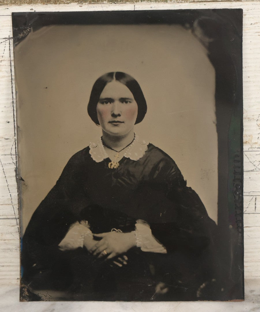 Lot 171 - Antique Full Plate Tintype Photograph Of A Young Woman With Center Parted Hair, Folded Hands, Gold Tinted Cross, Ring, Jewelry, White Painted Details