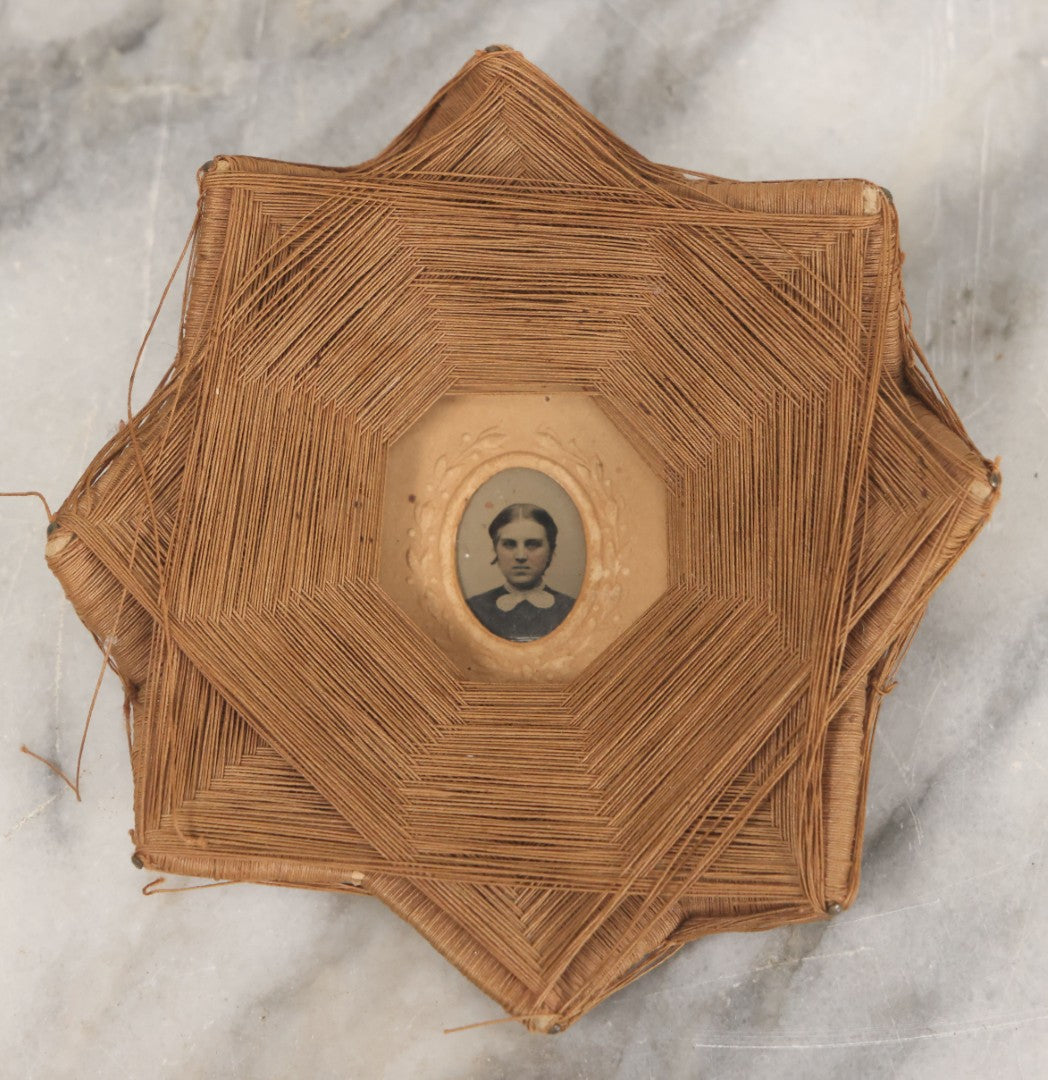 Lot 013 - Antique Folk Art String Frame With Gem Sized Tintype Of Young Woman With White Lace Collar, As Found, 4-1/2" x 4-1/2"