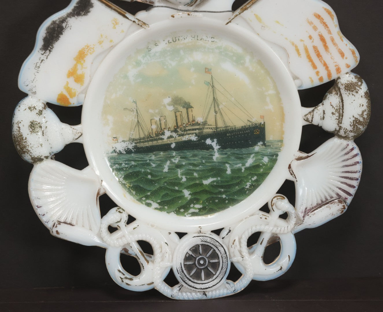 Lot 085 - Antique Milk Glass Collectible Souvenir Plate From The S.S. Deutschland, German Ocean Liner, Hamburg America Line (H.A.P.A.G.), With Lithographed Depiction Of Ship, Remnants Of Original Paint, Note Small Crack, 7-3/8" Diameter