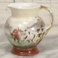 Lot 088 - Antique Royal Bayreuth Porcelain Creamer With White And Brown Cow Graphics, Painted Landscape Scene, 3-5/8" Height