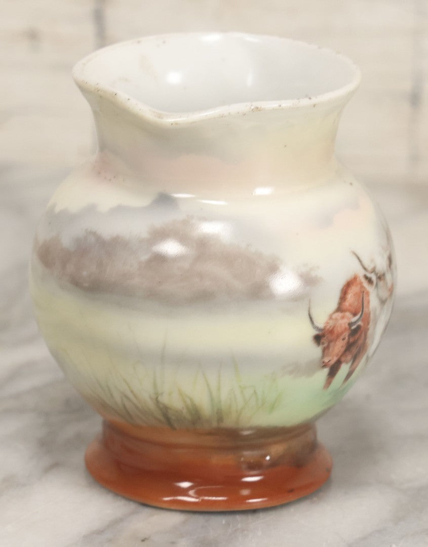 Lot 088 - Antique Royal Bayreuth Porcelain Creamer With White And Brown Cow Graphics, Painted Landscape Scene, 3-5/8" Height