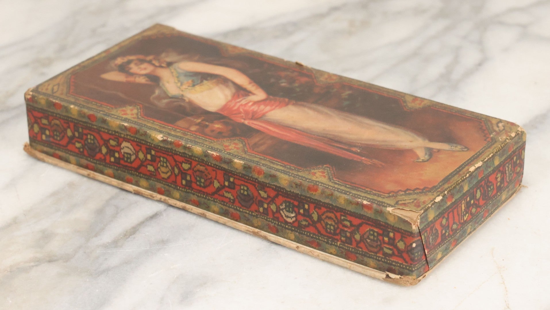 Lot 105 - Antique Paper Board Candy Box With Lithograph Wrapped Lid With Exotic Woman Graphics, Paper Label On Bottom From G.B. Co., Springfield, Massachusetts