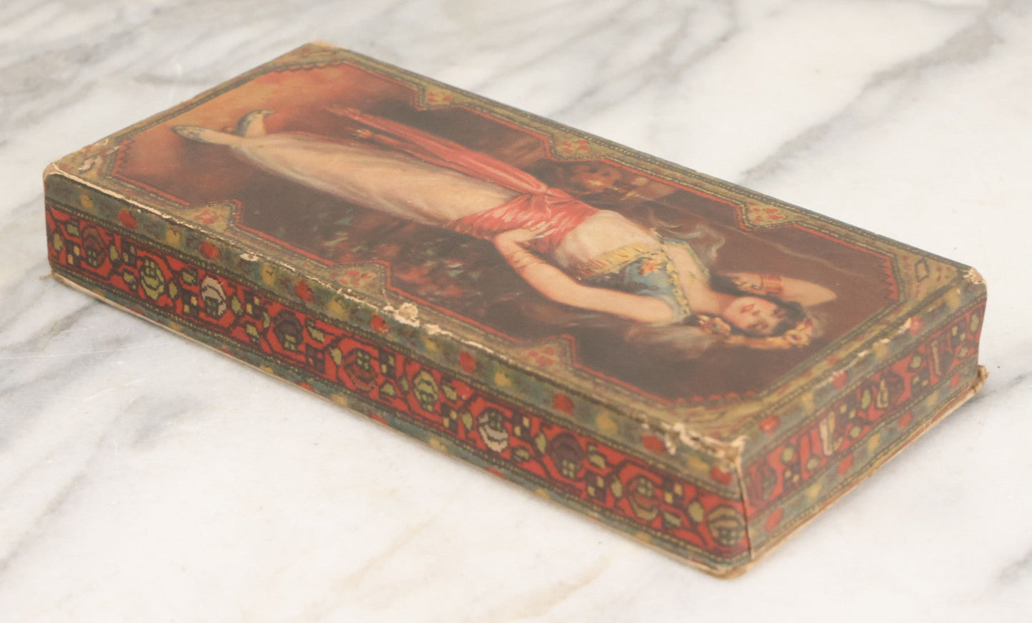 Lot 105 - Antique Paper Board Candy Box With Lithograph Wrapped Lid With Exotic Woman Graphics, Paper Label On Bottom From G.B. Co., Springfield, Massachusetts