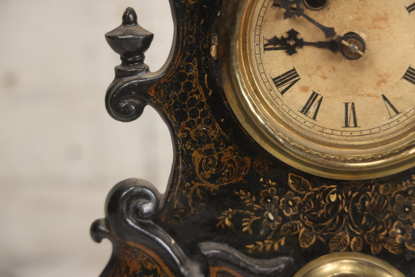 Lot 006 - Antique Metal And Wood Mantel Clock With Hand Painted Details, Paper Clock Face, And Domed Pendulum Window, With Paper Label Inside, Manufactured By The Waterbury Clock Co., Waterbury, Connecticut, Untested, No Pendulum, 13-1/8" H