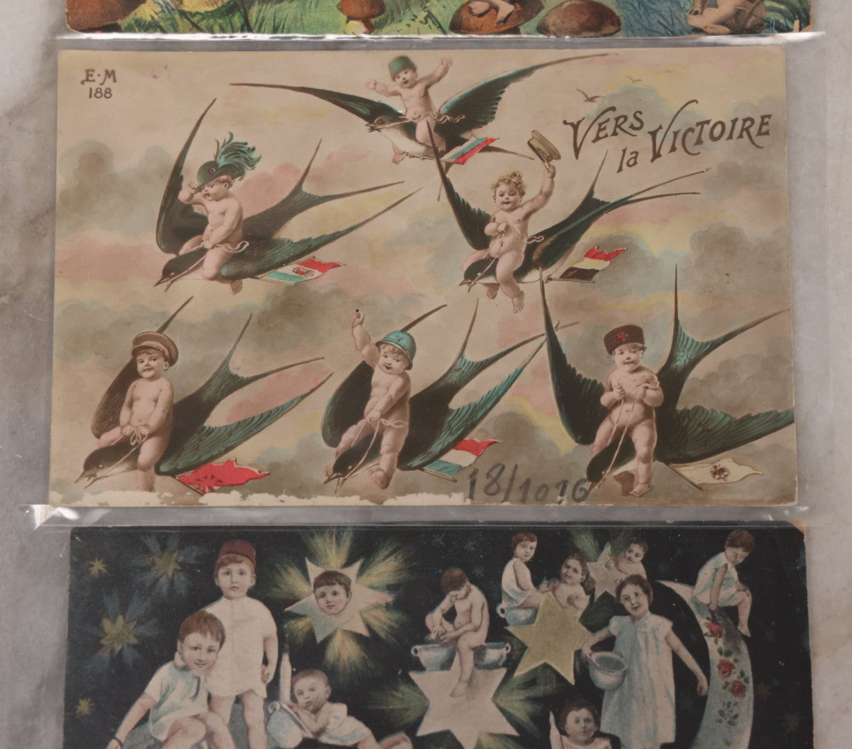 Lot 107 - Grouping Of Three Antique Foreign Postcards Of Children And Cherubs In Fantastical Scenes Including Flying On Birds, Napping On The Moon, And Sitting On Giant Mushrooms