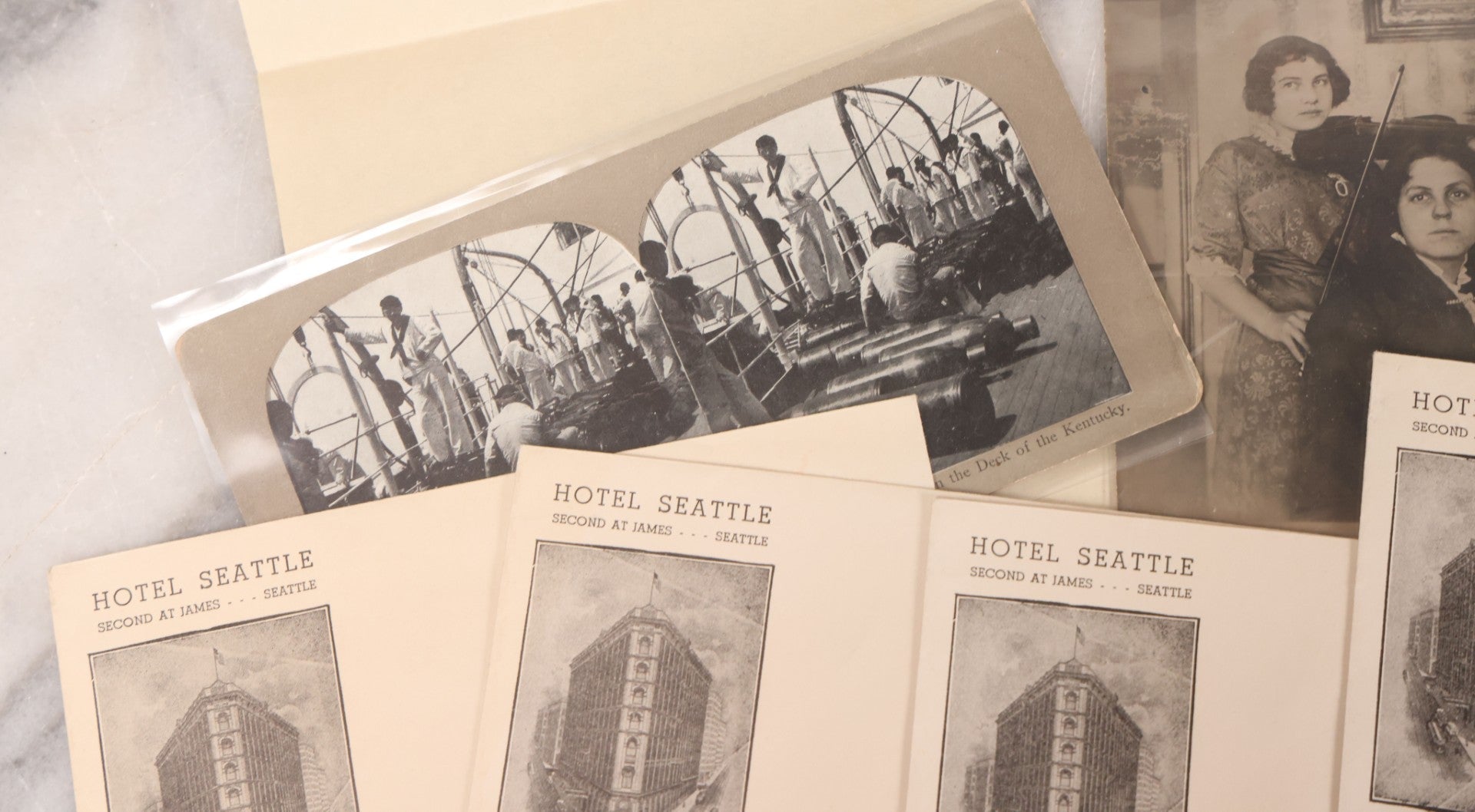 Lot 110 - Nine Piece Vintage And Antique Ephemera Grouping Including Real Photo Postcards R.P.P.C. Of Women With Violin, Man In Uniform, Landscape C.D.V. Photograph, Envelopes And Stationary From Seattle Hotels, And Stereoview Of The Deck Of Battleship