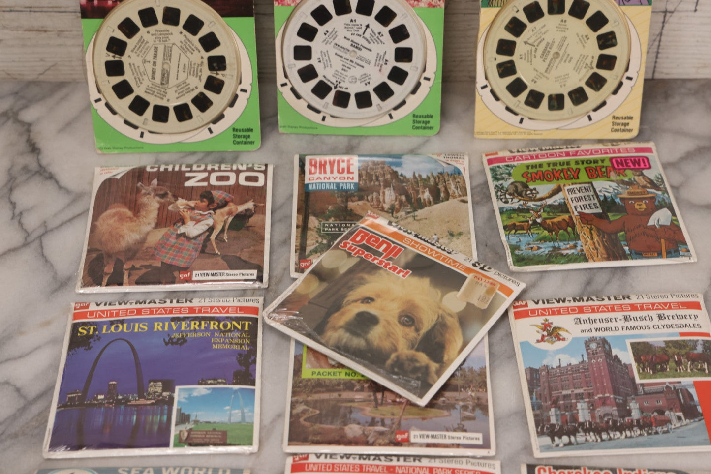 Lot 115 - Thirteen Piece Vintage Sealed Viewmaster Stereoview 3D Discs Including Cabbage Patch Kids, Bambi, Disney On Parade, Smokey Bear, And Many Travel Editions