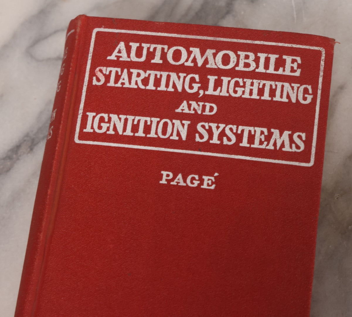 Lot 128 - Two Piece Vintage Automobile Grouping Including Ford Model A. Clymer Manual, Copyright 1928, And "Automobile Starting, Lighting, And Ignition Systems" Book By Victor W. Page, Copyright 1925