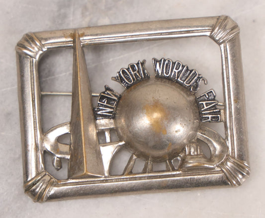 Lot 067 - Vintage New York World's Fair Silver Colored Brooch With Trylon And Perisphere, Marked Copyright N.Y.W.E., License No. 1625