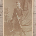 Lot 084 - Antique Carte De Visite C.D.V. Photograph Of Young Boy Posing With Rifle, Byrne & Co. Photographers To Her Majesty, Hill Street, Richmond, England