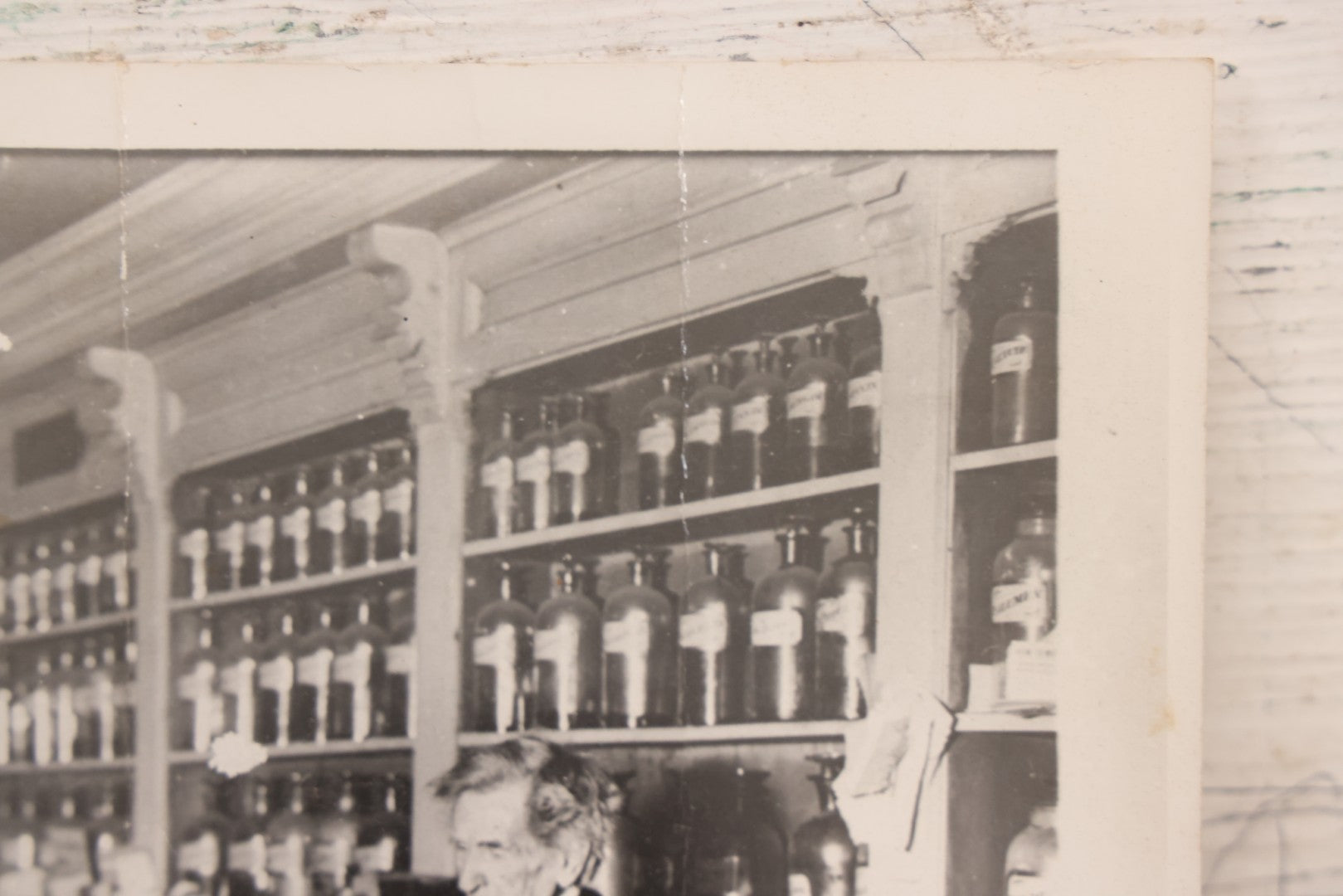 Lot 093 - Antique Large Format Photograph Of Elderly Pharmacist Compounding Medicine At The Pharmacy Counter, With Many Apothecary Bottles And Tools Visible