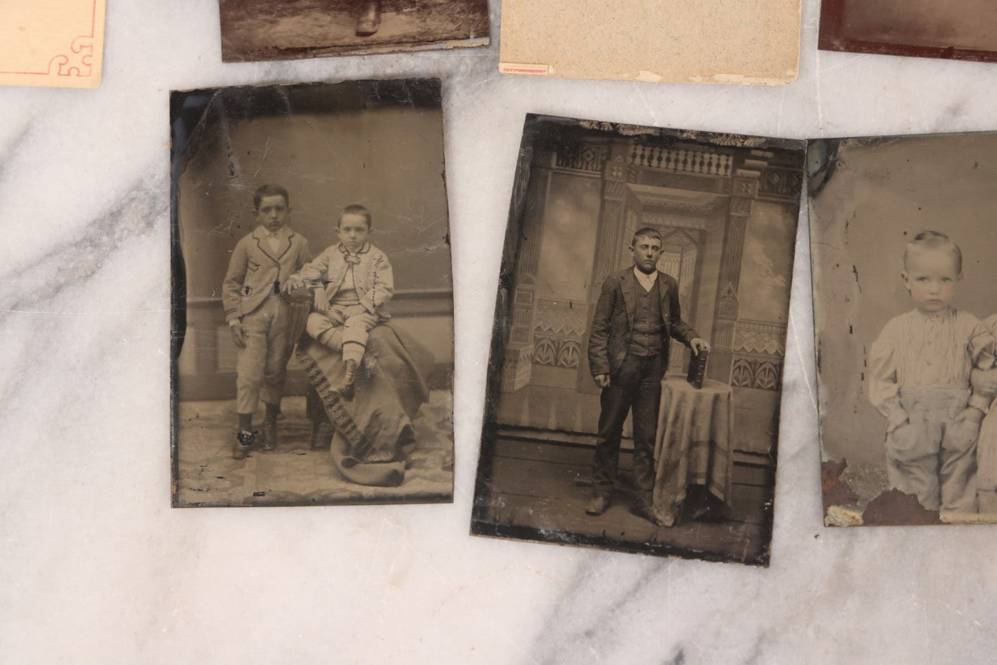 Lot 095 - Grouping Of Sixteen Antique Tintype Photographs Of Men Women And Children Including Two Children In Chairs, Brother And Sister, With Hand Tinting, Young Man Standing With Book, Family Portrait, And More