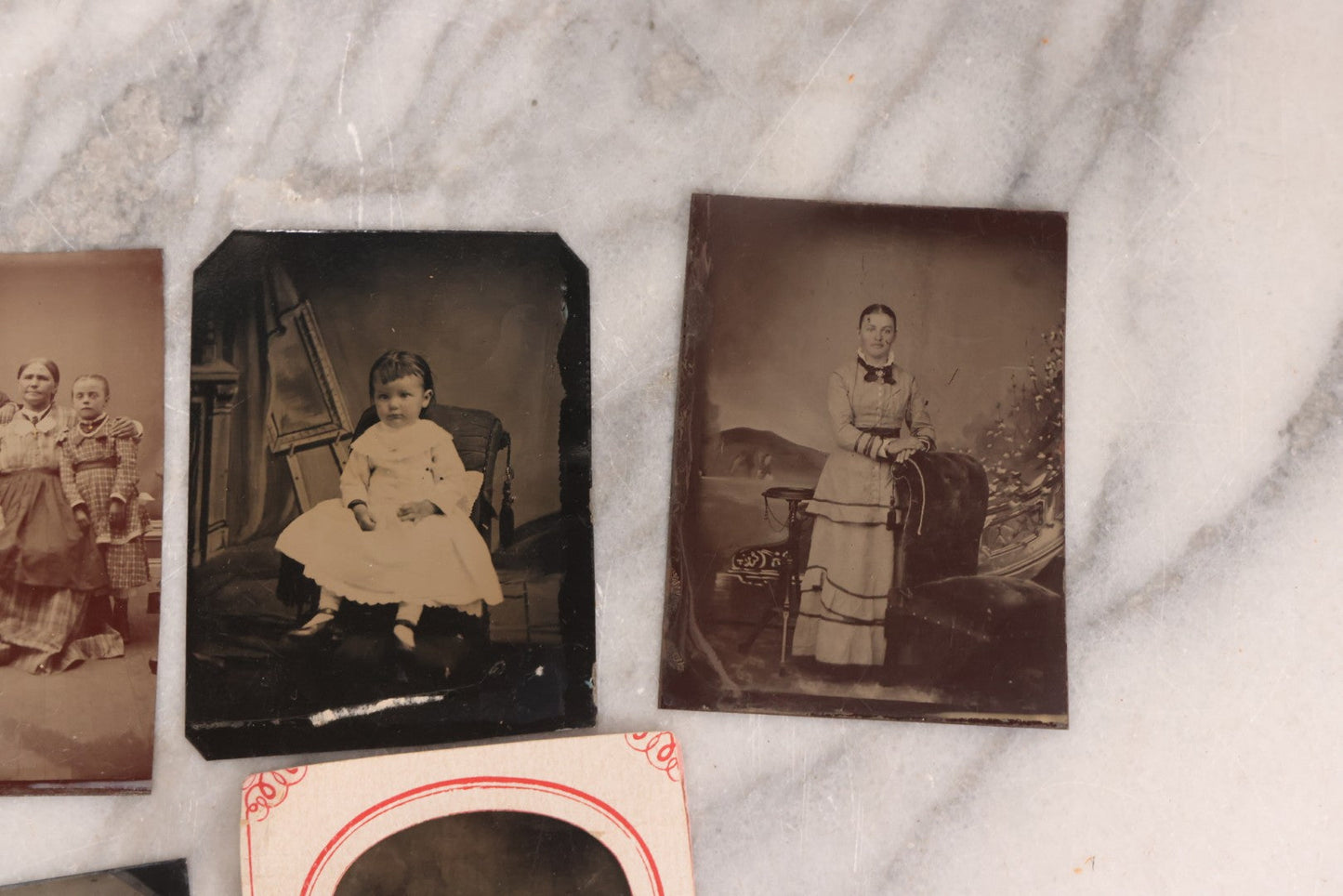 Lot 095 - Grouping Of Sixteen Antique Tintype Photographs Of Men Women And Children Including Two Children In Chairs, Brother And Sister, With Hand Tinting, Young Man Standing With Book, Family Portrait, And More