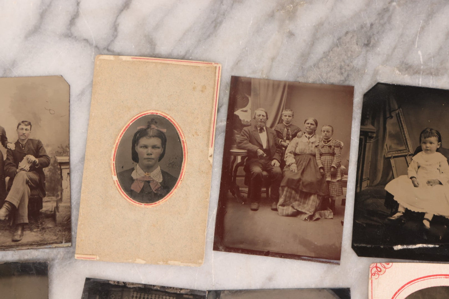 Lot 095 - Grouping Of Sixteen Antique Tintype Photographs Of Men Women And Children Including Two Children In Chairs, Brother And Sister, With Hand Tinting, Young Man Standing With Book, Family Portrait, And More