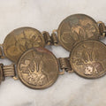 Lot 048 - Vintage Pressed Brass Good Luck Charm Necklace With Four Leaf Clover, Lucky Penny, Dice, Horseshoe, And Wishbone, With Fifteen Pressed "Coins"