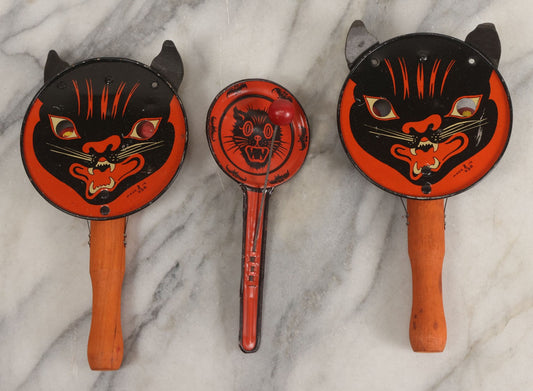 Lot 062 - Grouping Of Three Vintage Tin Lithograph Halloween Noisemakers Including Snarling Black Cat With Paper Ears Noise Making Eyeballs Marked T.C., Made In U.S.A., And Black Cat With Bats Border