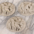 Lot 078 - Grouping Of Three Vintage Concrete Wall Plaques Depicting Cherubs In Different Scenes, Including With Lamb