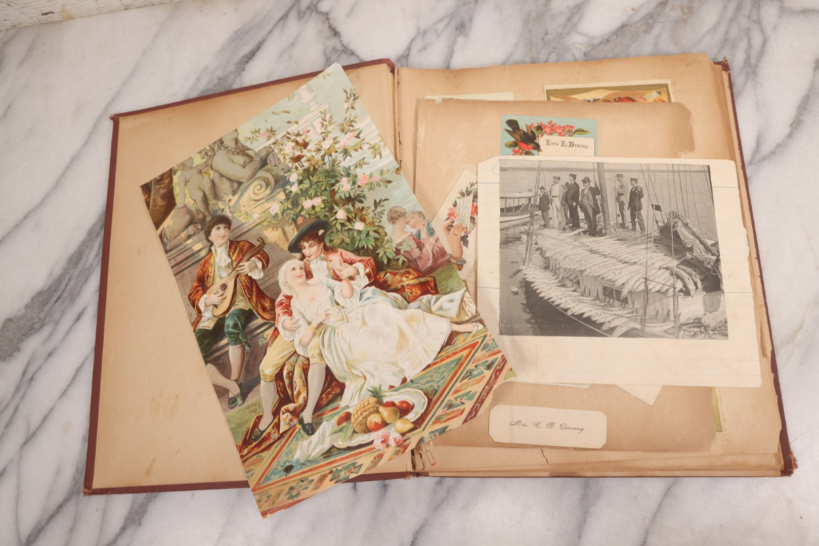 Lot 114 - Antique Victorian Scrapbook Album With Textured Urns On Cover Containing 70+ Pieces Including Trade Cards, Die Cuts, Calling Cards, And Other Scraps