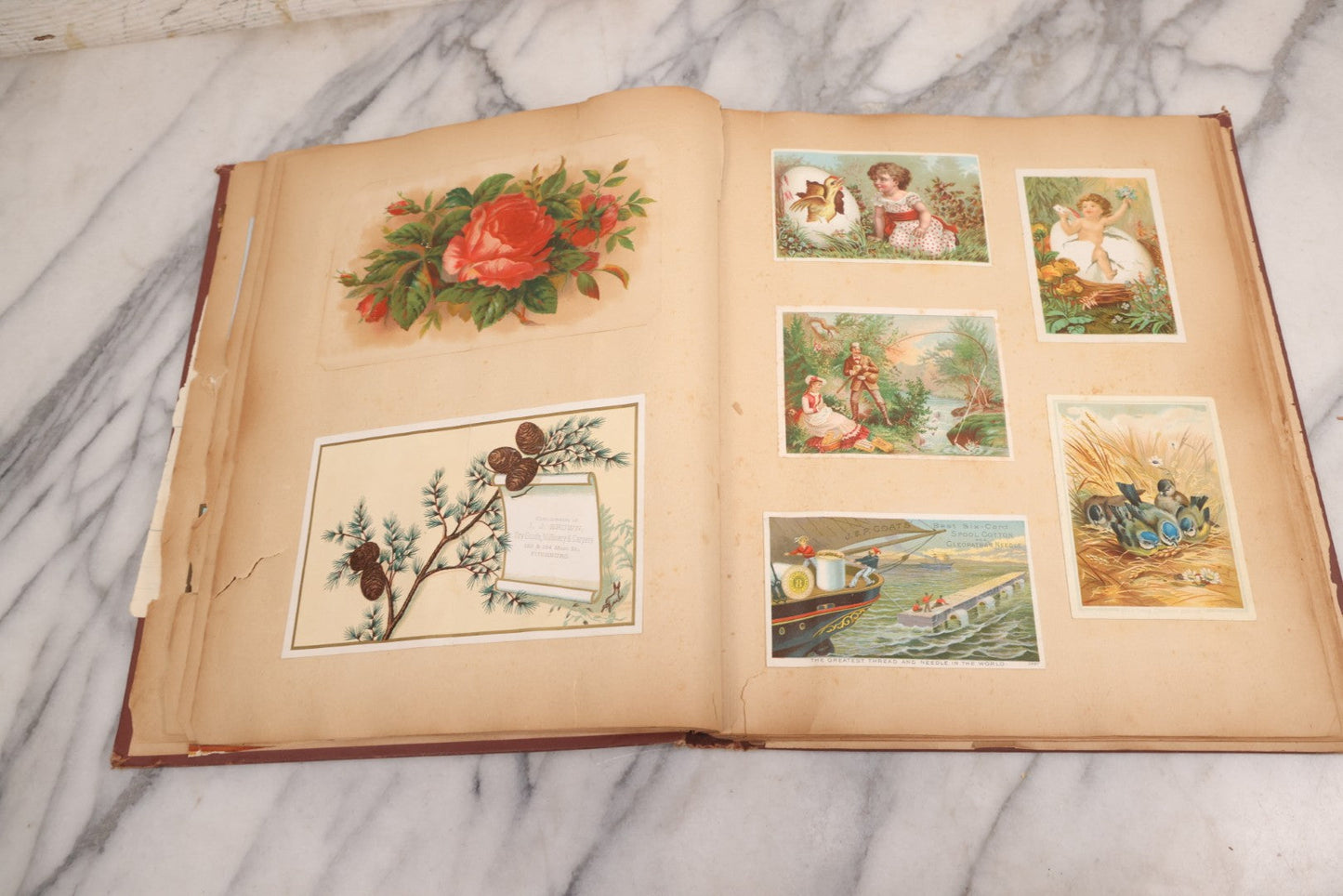 Lot 114 - Antique Victorian Scrapbook Album With Textured Urns On Cover Containing 70+ Pieces Including Trade Cards, Die Cuts, Calling Cards, And Other Scraps
