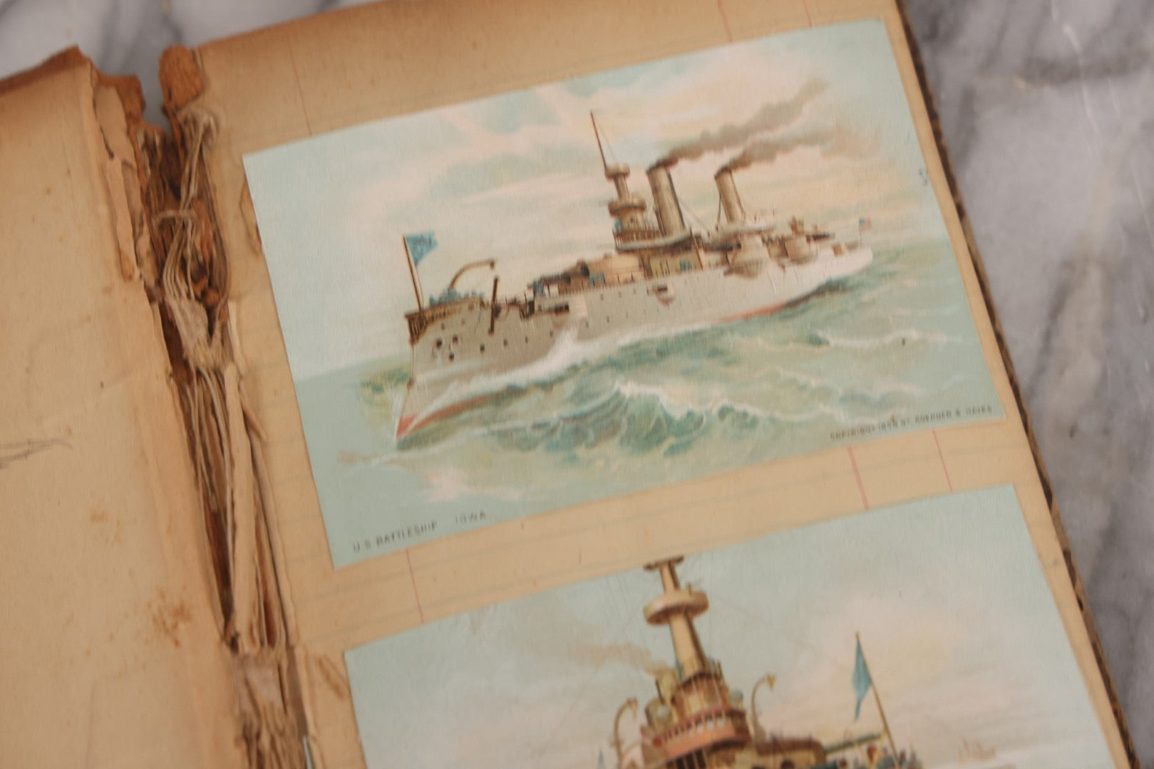 Lot 118 - Antique Scrapbook Album Made From An Old Cash Book Ledger Containing 15 Lithographed Card Featuring United States Battleships Of The Spanish American War Era, Cards Copyright 1898 By Koerner & Hayes, With Four Additional Cards, Doodles, Etc.