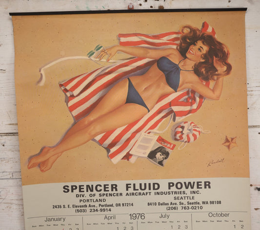 Lot 135 - Vintage Pinup Advertising Wall Calendar For 1976, Woman In Bathing Suit On Beach, Illustrated By Randall, Advertising Spencer Fluid Power, Portland, Oregon And Seattle, Washington, And Aeroquip, Jackson, Michigan