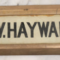 Lot 062 - Vintage Reverse Painted Name Plate Door Tag For G.W. Hayward In Brass Mounting Frame, Note Cracked, 7-5/8" x 3"