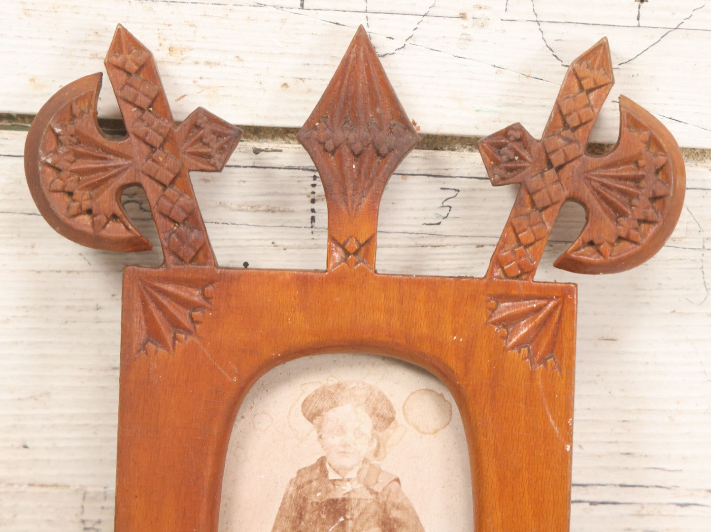 Lot 083 - Antique Folk Art Hand Carved Wooden Photo Frame With Crossed Axes, Spear Motifs, With Cabinet Card Photo Of Little Boy