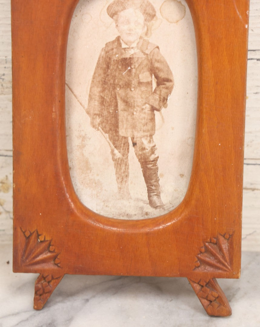 Lot 083 - Antique Folk Art Hand Carved Wooden Photo Frame With Crossed Axes, Spear Motifs, With Cabinet Card Photo Of Little Boy