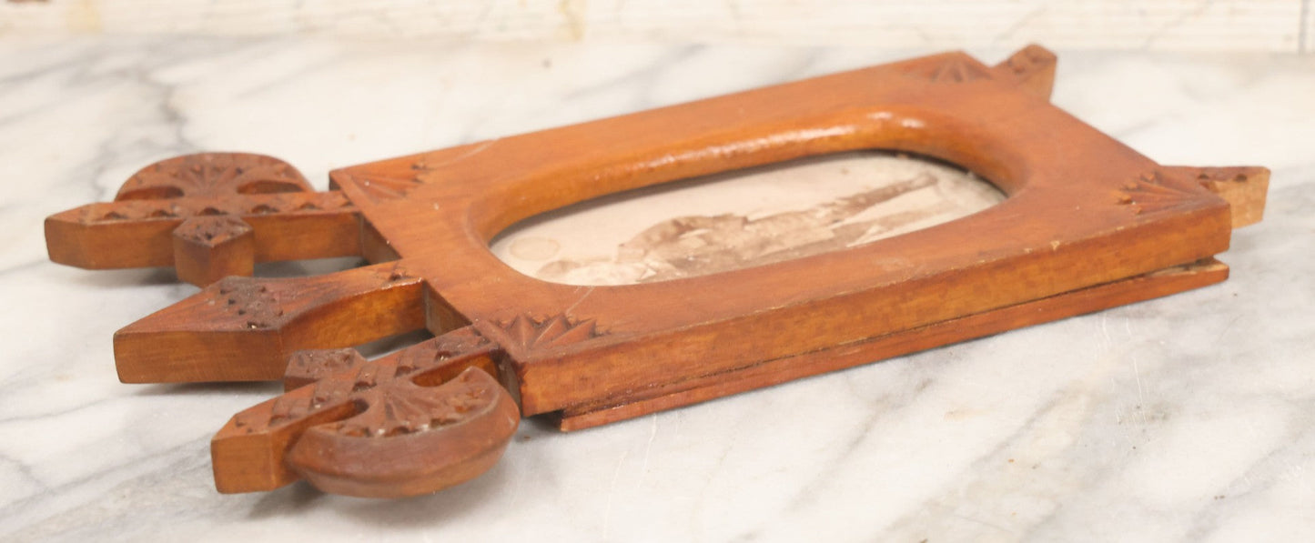 Lot 083 - Antique Folk Art Hand Carved Wooden Photo Frame With Crossed Axes, Spear Motifs, With Cabinet Card Photo Of Little Boy