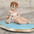 Lot 107 - Antique Porcelain Dresser Box Lid With Child And Kitten Figural Motif, 3-3/4" H