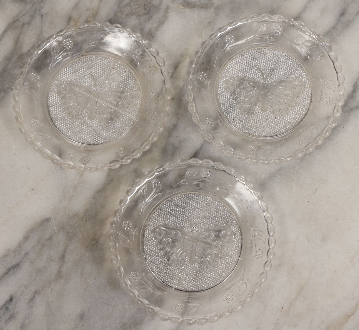 Lot 111 - Grouping Of Three Antique Pressed Glass Butterfly Cup Plate Coasters