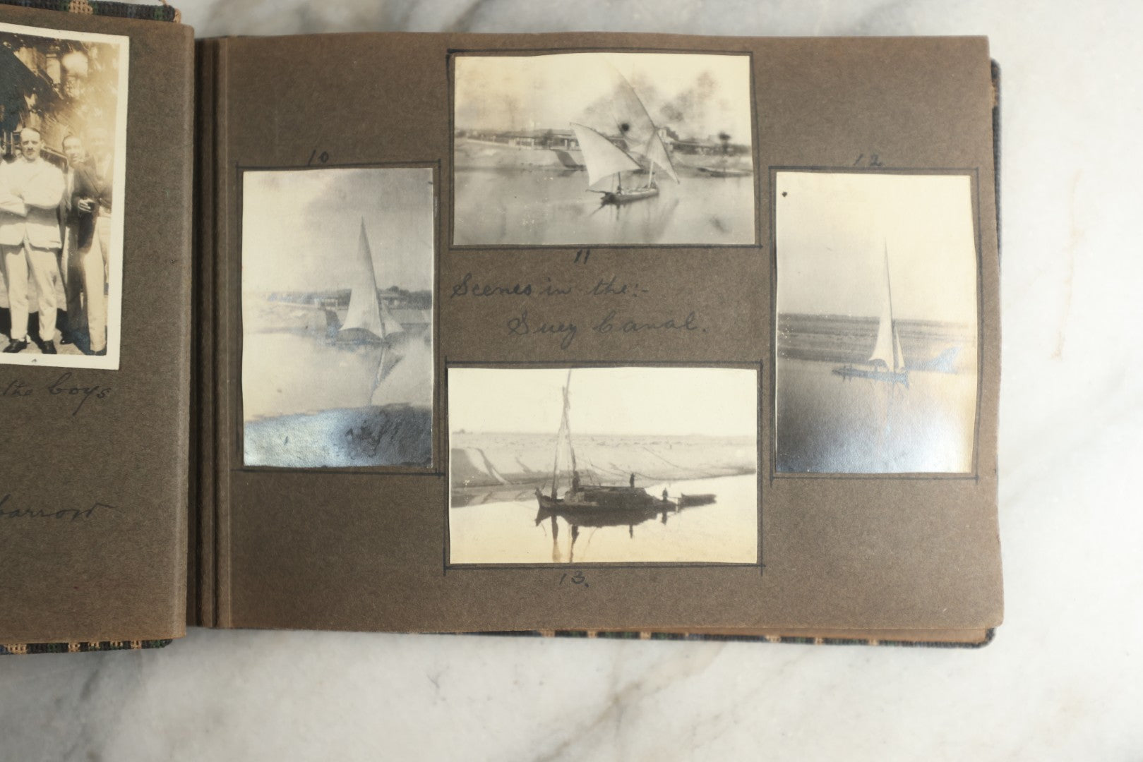 Lot 113 - Antique Snapshot Photo Album With Cloth Cover, Containing Approximately 75 Photographs With Captions, Mostly Of Travel, Including To Sea Travel, Locations In Asia, Sail Boats In Suez Canal, Singapore, Hong Kong, And More, Circa 1920s