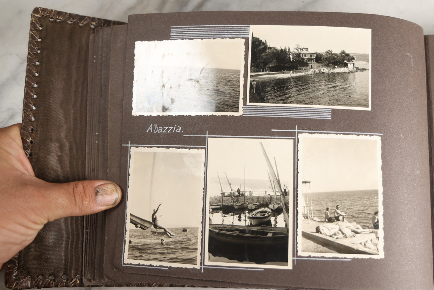 Lot 122 - Antique Snapshot Photo Album, Containing Approximately 100 Photographs With Captions In Czech, Detailed Pin Striping And Painting On Pages, Mostly Photos Of Travel Around Europe, Including Italy, The Alps, Croatia, Ukraine, And More, Circa 1920