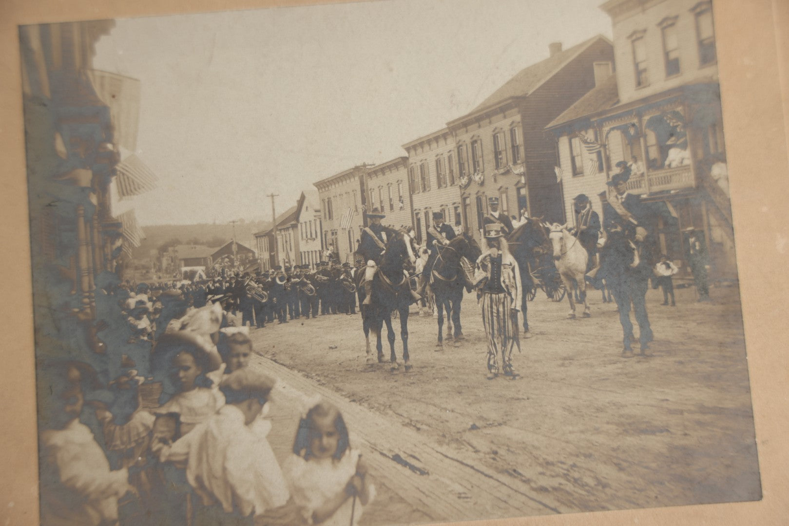 Lot 123 - Antique Boarded Photograph Of A Parade, Likely Fourth Of July, Including Man In Uncle Sam Costume Horseback Mounted Military, Onlookers, American Flags, Downtown Area, Possibly Baltimore Maryland, Verso Marked John Hopkins