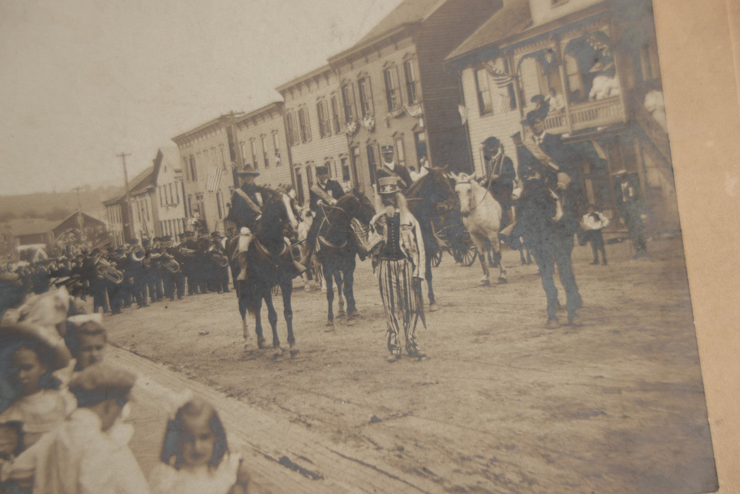 Lot 123 - Antique Boarded Photograph Of A Parade, Likely Fourth Of July, Including Man In Uncle Sam Costume Horseback Mounted Military, Onlookers, American Flags, Downtown Area, Possibly Baltimore Maryland, Verso Marked John Hopkins