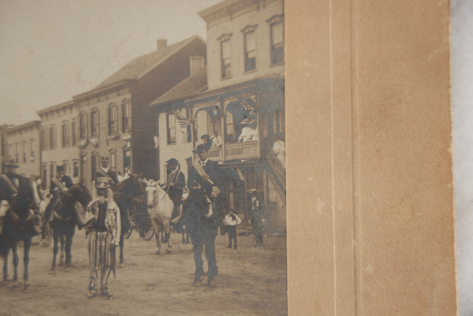 Lot 123 - Antique Boarded Photograph Of A Parade, Likely Fourth Of July, Including Man In Uncle Sam Costume Horseback Mounted Military, Onlookers, American Flags, Downtown Area, Possibly Baltimore Maryland, Verso Marked John Hopkins